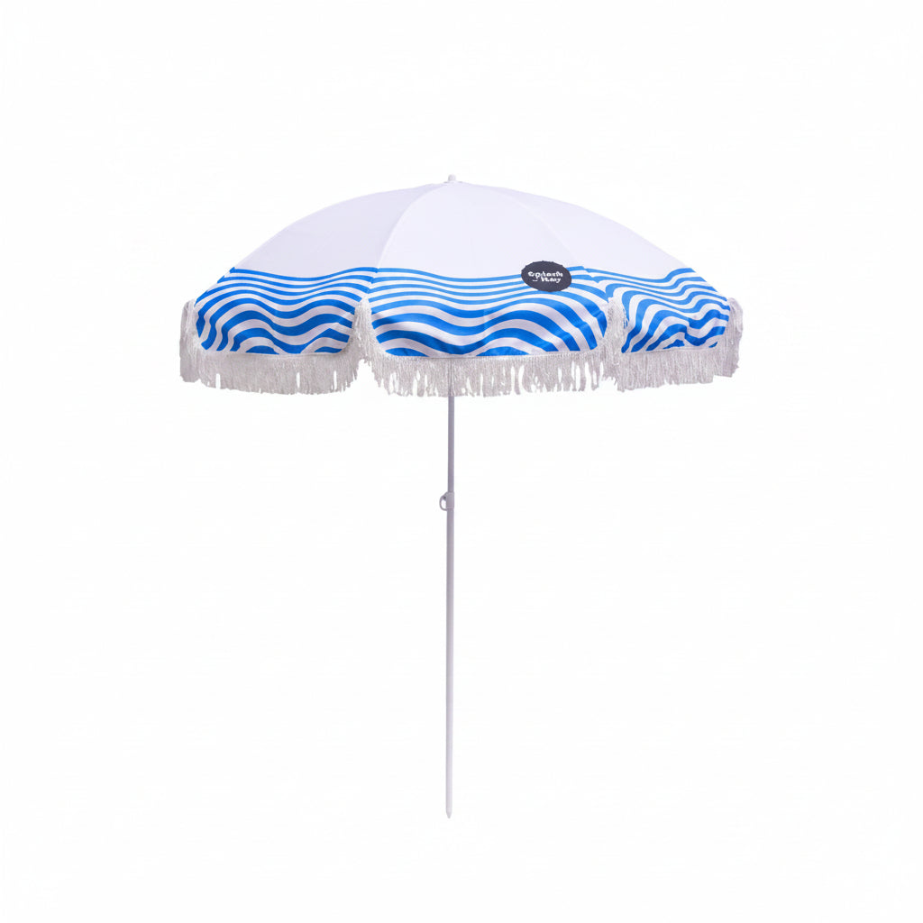 White beach umbrella with blue wave pattern and fringe on a white background