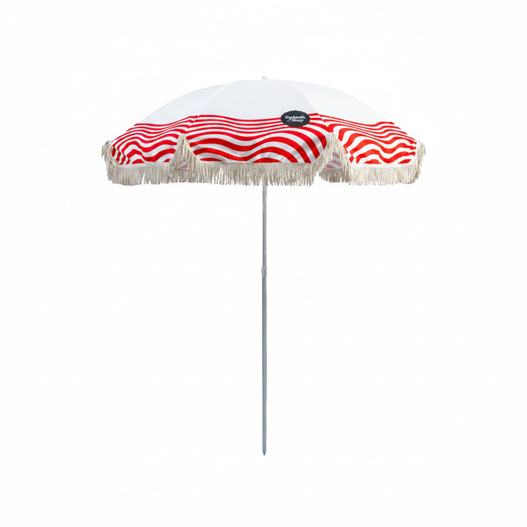 Red and white striped beach umbrella with fringe on a white background